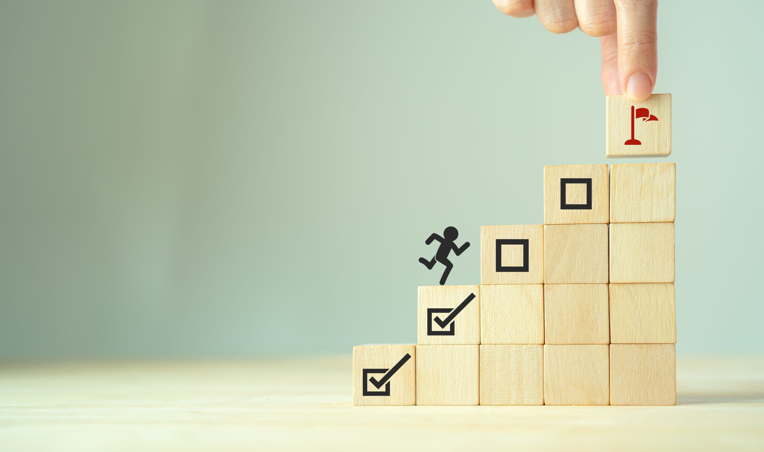 Wooden blocks stacked like steps symbolize growth and personal development.